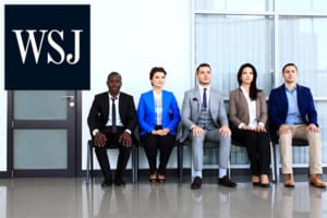 people in professional attire sitting in a line