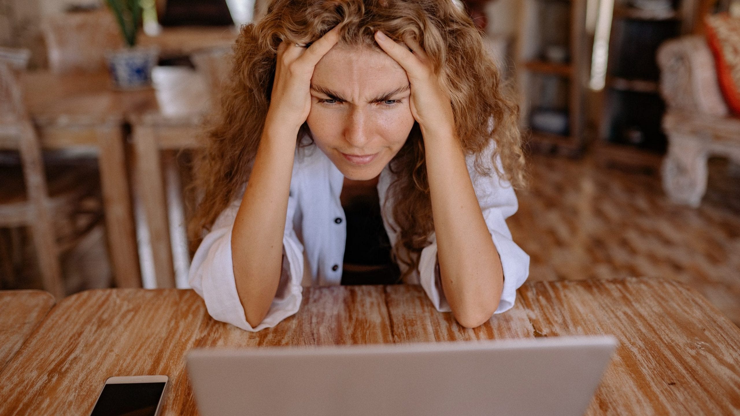 Woman stressed looking at her laptop