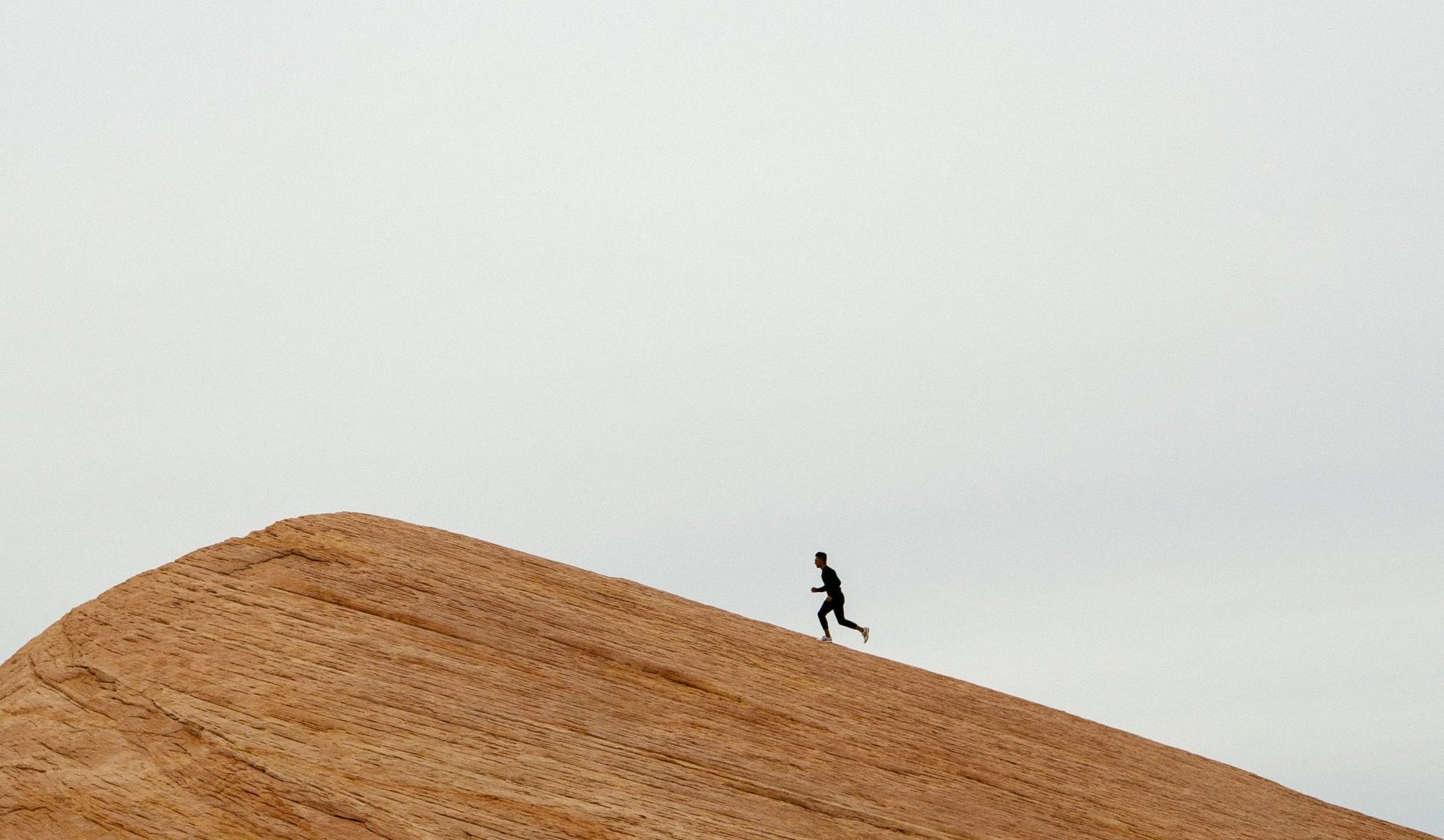 man running up steep hill