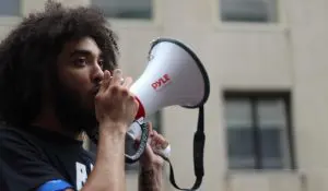 person speaking into megaphone