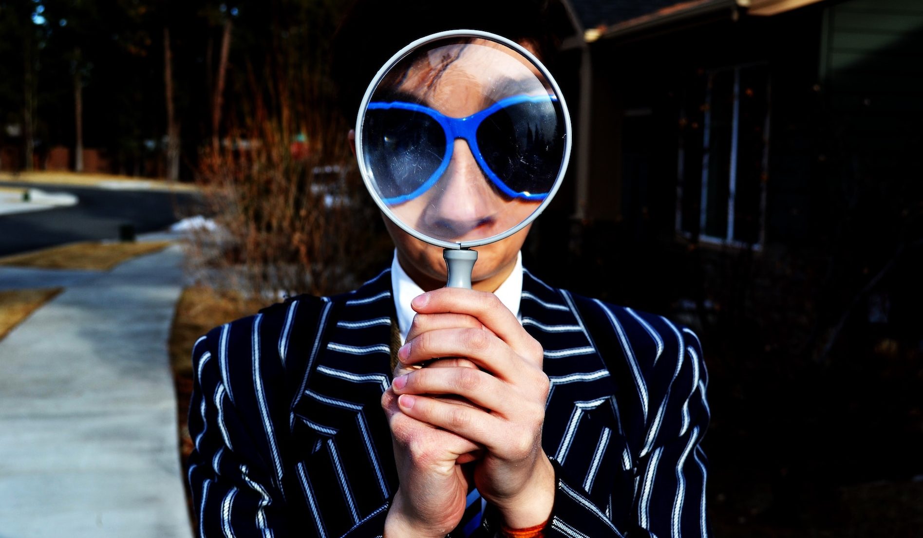 magnifying glass held up to someone's face