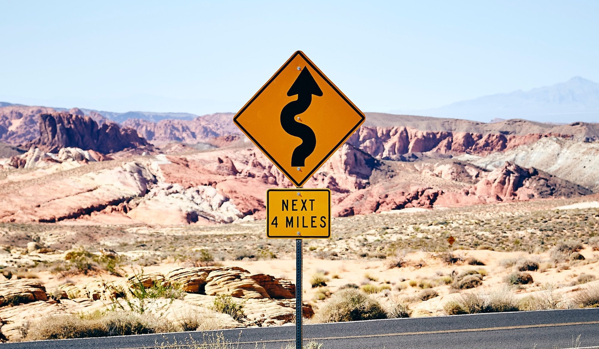 next 4 miles curvy road sign