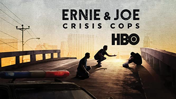 Cover art for HBO Series: Ernie & Joe Crisis Cops. Photo of two officers trying to help and person sitting on sidewalk