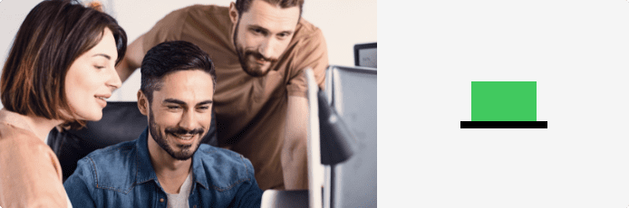 coworkers smiling and looking at computer together