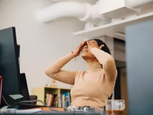 A woman looks stressed at work