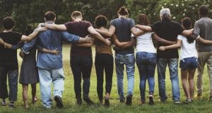 a group of young people with their arms around each other