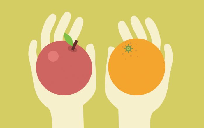 An image of two hands holding an apple and an orange, illustrating the nature of choice on the Your Brain at Work Blog for the NeuroLeadership Institute.