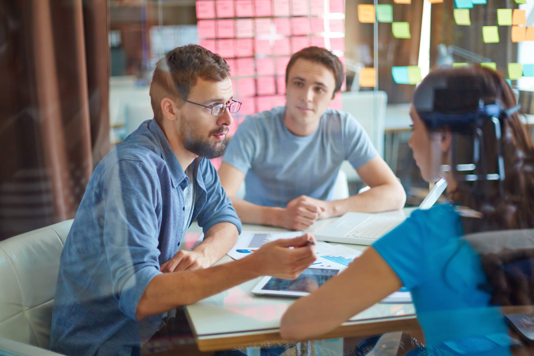 young-man-consulting-his-business-partner-at-meeting-in-office-SBI-300739949_50